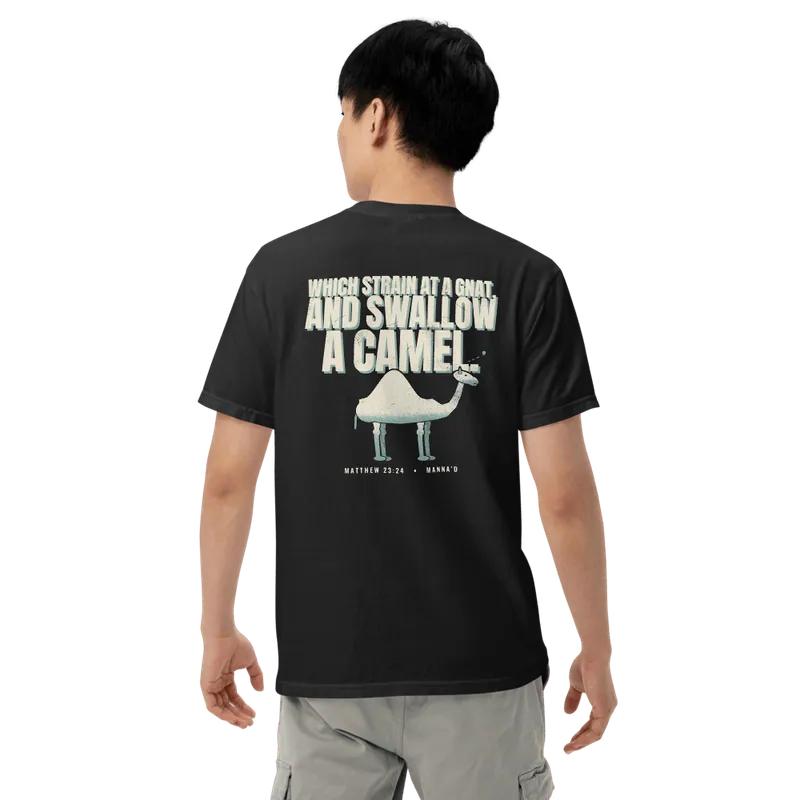 Back of a black Manna’d tee printed: WHICH STRAIN AT A GNAT, AND SWALLOW A CAMEL. (Matt 23:24)